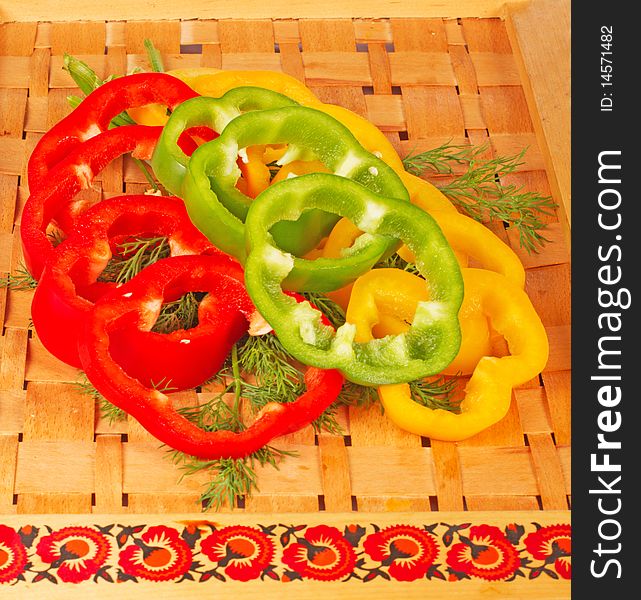 Sliced colorful paprika with dill on tray