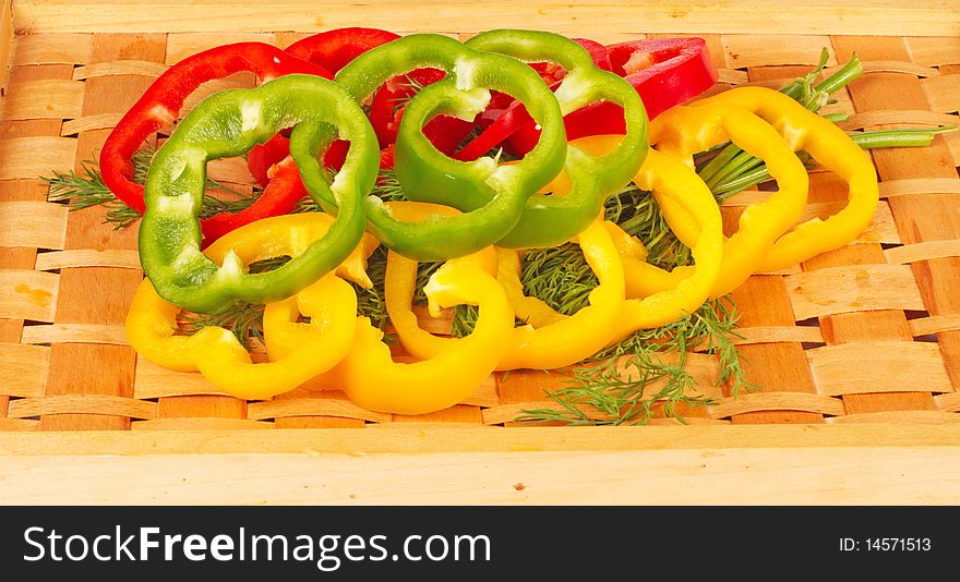 Sliced colorful paprika with dill on tray