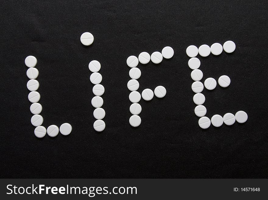 Word a life combined from white round tablets. Word a life combined from white round tablets