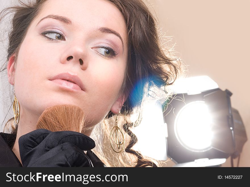 Brunet woman in black gloves. Make-up, hairstyle. Isolated.