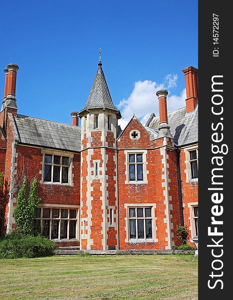 An imposing English Stately Home with Norman style Tower and tall chimneys and Mullion windows. An imposing English Stately Home with Norman style Tower and tall chimneys and Mullion windows