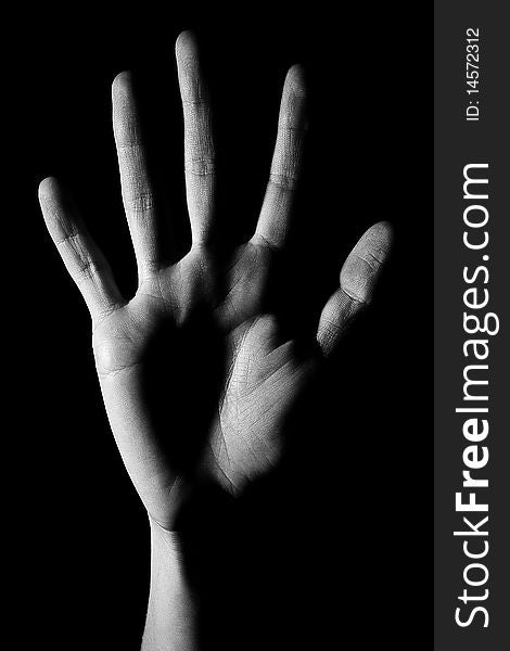 Human hand is drawn by light on a black background