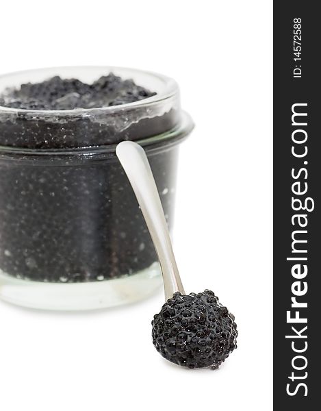 Black caviar in a glass jar on a white background