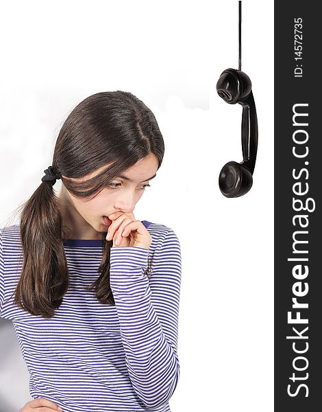Thinking young girl and retro telephone receiver