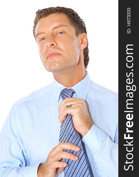 Portrait of a businessman fixing necktie