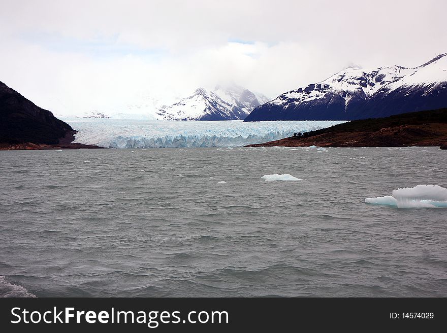 View to the connection of the glacier with nearby mountain. View to the connection of the glacier with nearby mountain