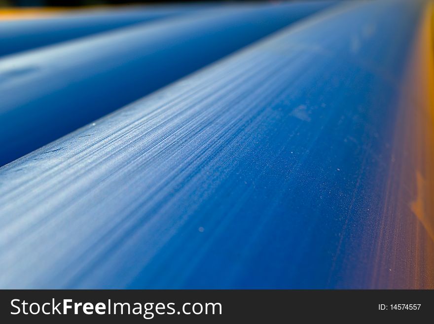 Blue Pipelines used for Water Transportation, Plastic Artificial, pipe, bright light flooded orange yellow