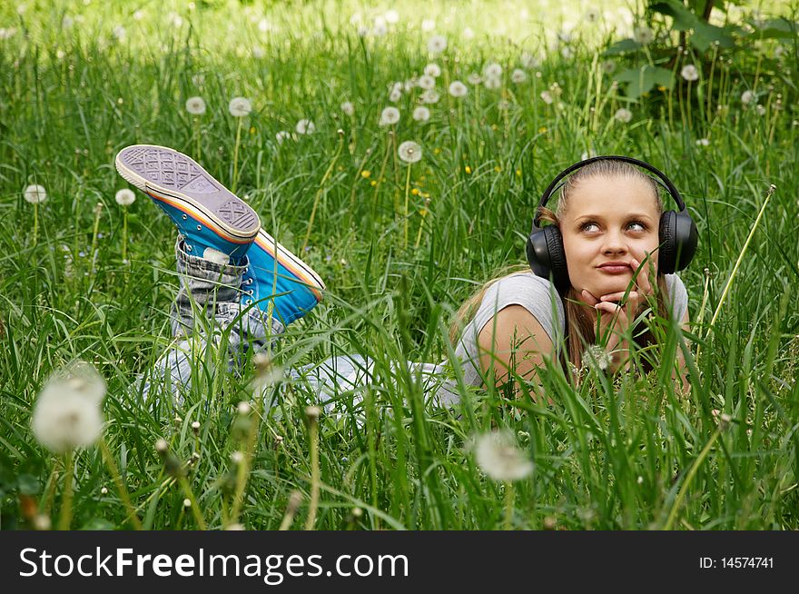 Girl listen music on meadow