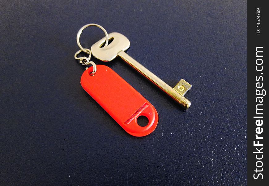 Key with red label on a blue background