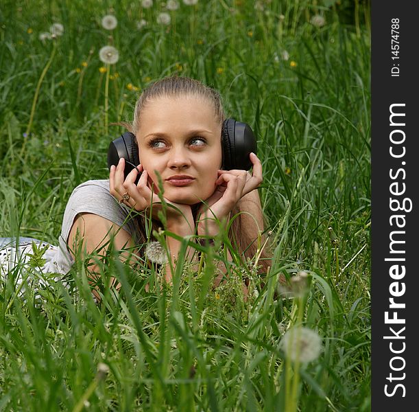 Girl listen music on meadow