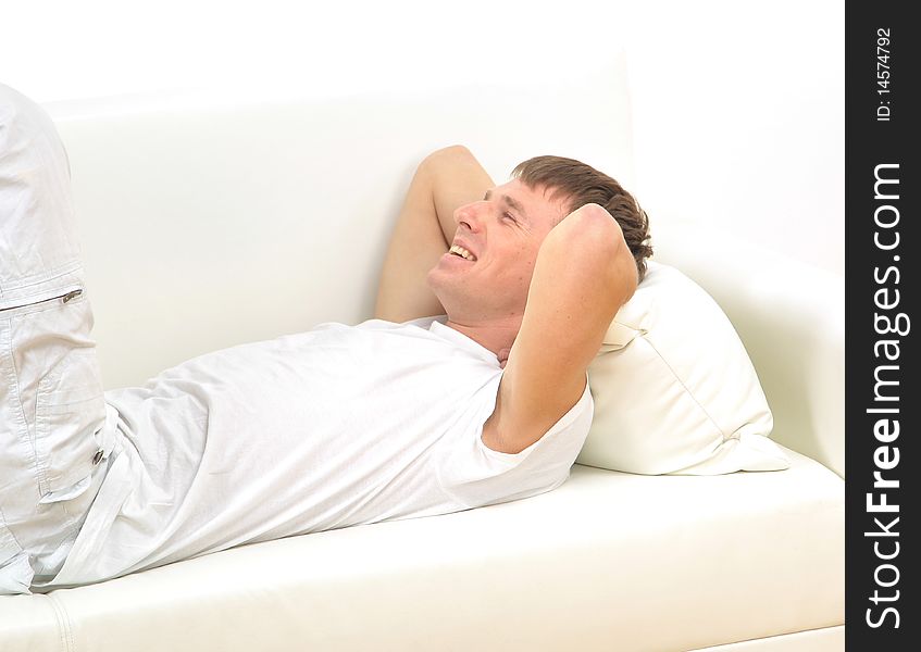 Young guy relaxing on sofa in home