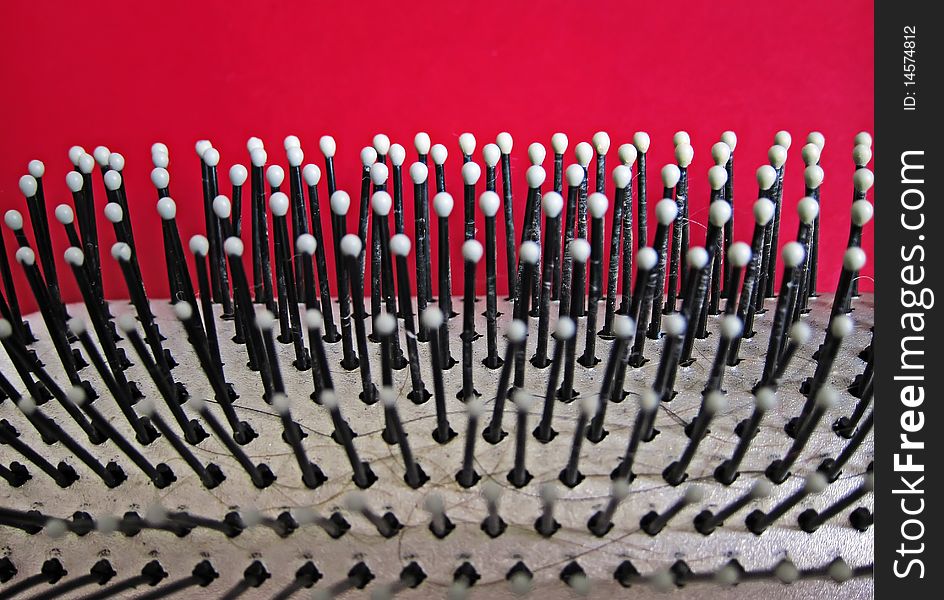 Detail of a wire brush on a red background