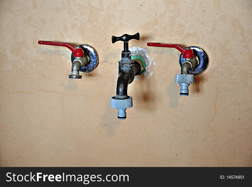 Three water taps with colored lever. Three water taps with colored lever