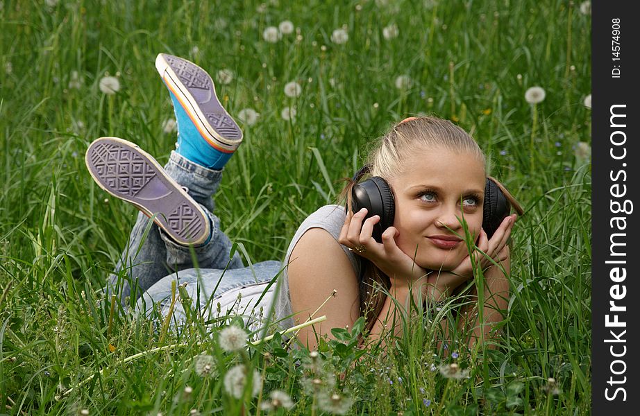 Girl listen music on meadow