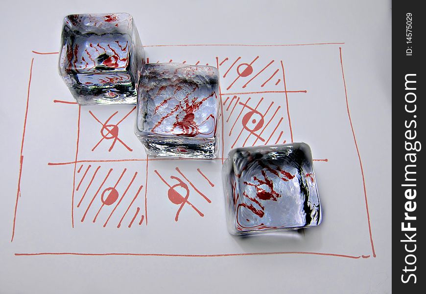 Three crystal cubes on a red drawing