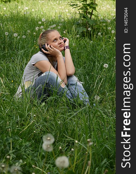 Girl listen music on meadow