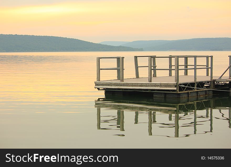 Sunrise on lake with view of dock. Sunrise on lake with view of dock