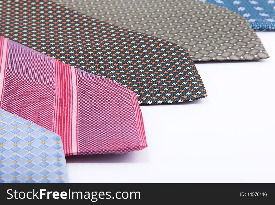 Red,  blue, gray, black ties over white background