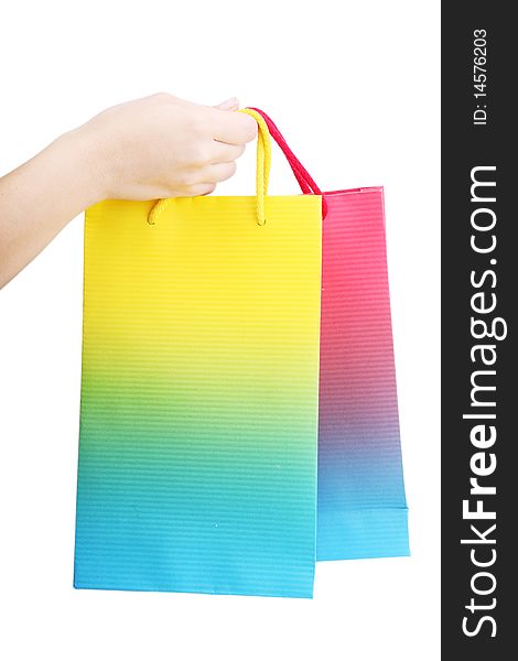 Hand holding two shopping bags on white background
