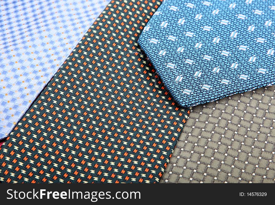 Blue, brown and black elegance ties. fabric background. Close up image