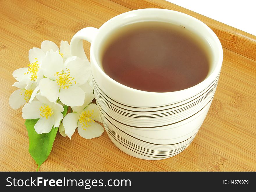 Mug of jasmine tea on a wooden tray