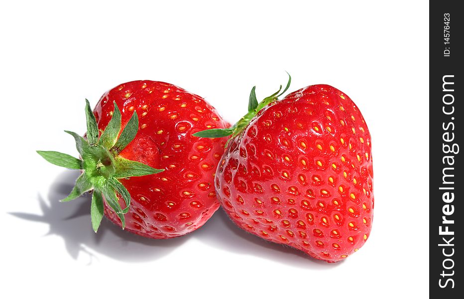 Two delicious red strawberries isolated on white background. Two delicious red strawberries isolated on white background