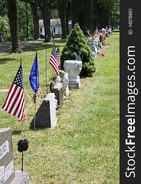 Flags and flowers stand out over the graves of loved ones. Flags and flowers stand out over the graves of loved ones