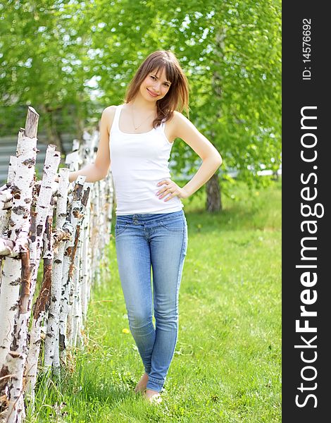 Beautiful girl and birch on a light background