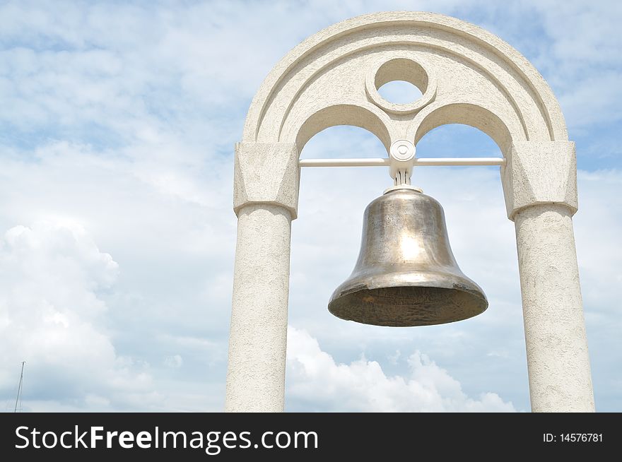 The old bell in the background of the sky,hanging on the arch. The old bell in the background of the sky,hanging on the arch