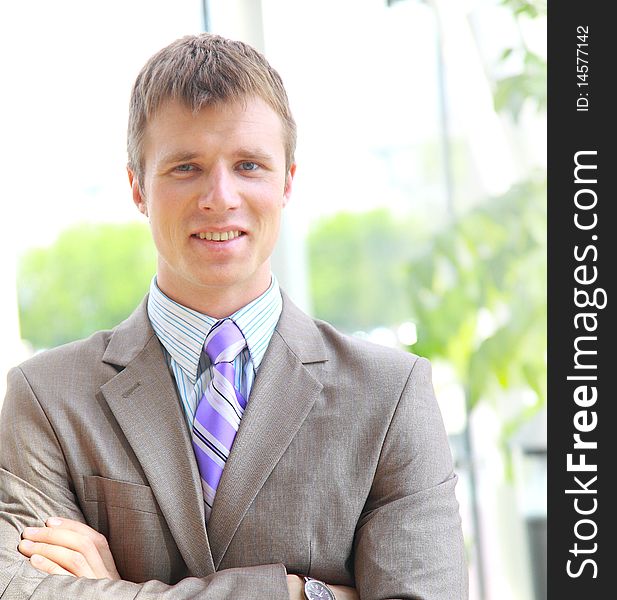 Portrait of a happy young businessman, smiling, indoor