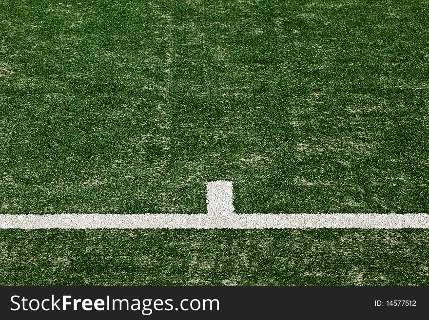 Close up of tennis court markings on a freshly laid turf.