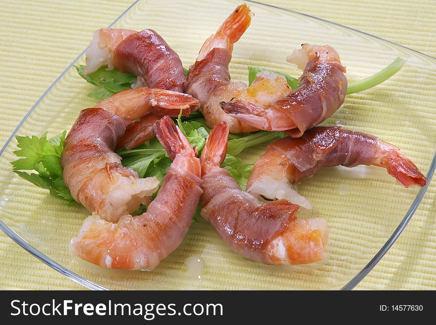 Shrimps rolled in prosciutto with celery