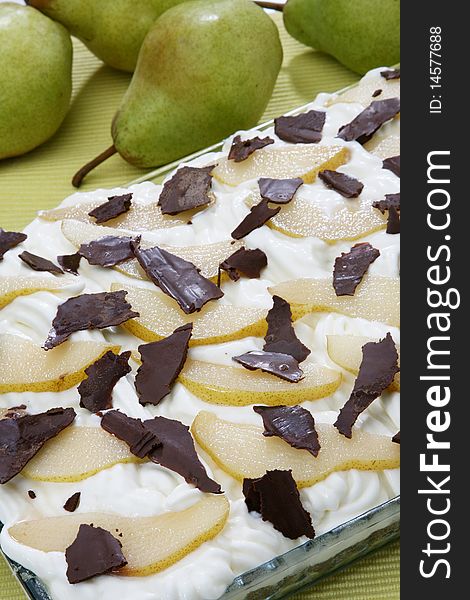 Pear cake with cream and slices of dark chocolate