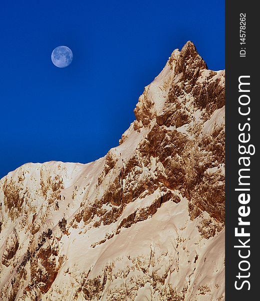 High alpine mountain with the moon. High alpine mountain with the moon