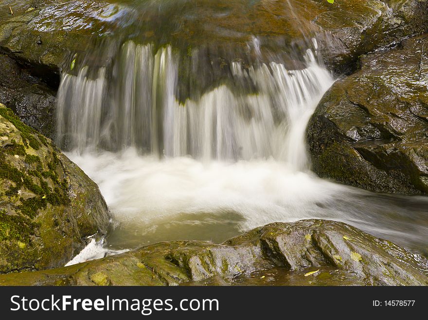 Beautiful waterfalls in the rocky river bed.