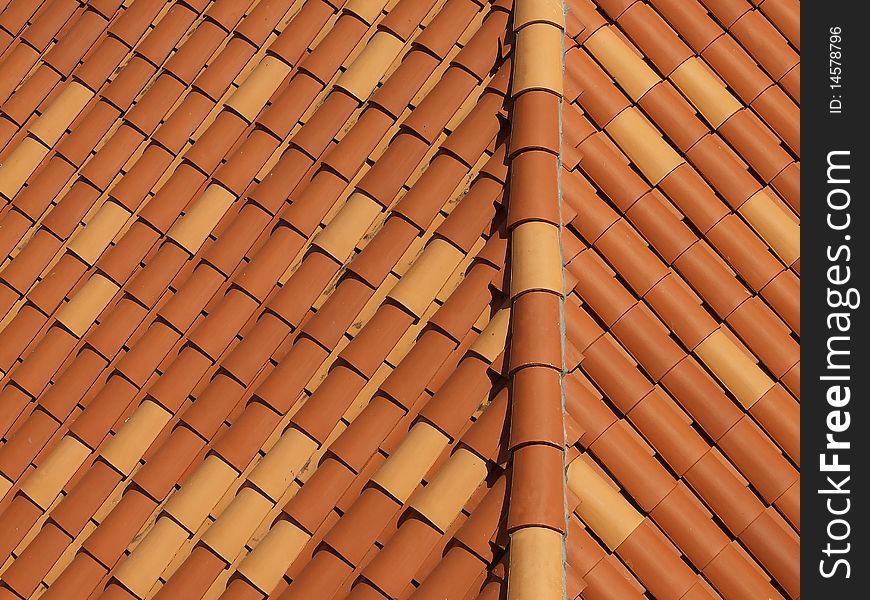 Roof covering of ceramic rustic tiles, aerial view, background. Roof covering of ceramic rustic tiles, aerial view, background