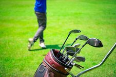 Golf Club Suit In Bag Cart And Blurred Golfer Hitting Golf Ball Stock Photos