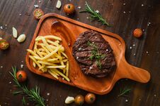 Grilled Kebab Grilled Meat Steak Lies With French Frieson A Rustic Old Elegant Wooden Cutlery Cutting Chopping Board Chili, With T Royalty Free Stock Photos