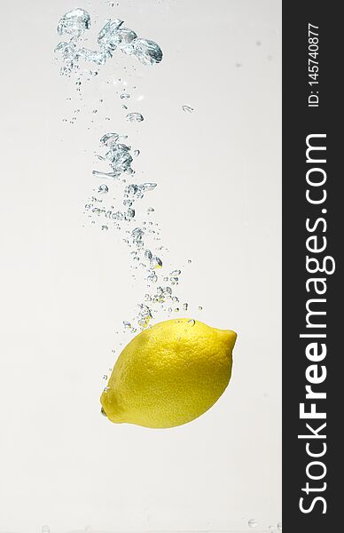 Fresh lemon drop on water with babble with white background