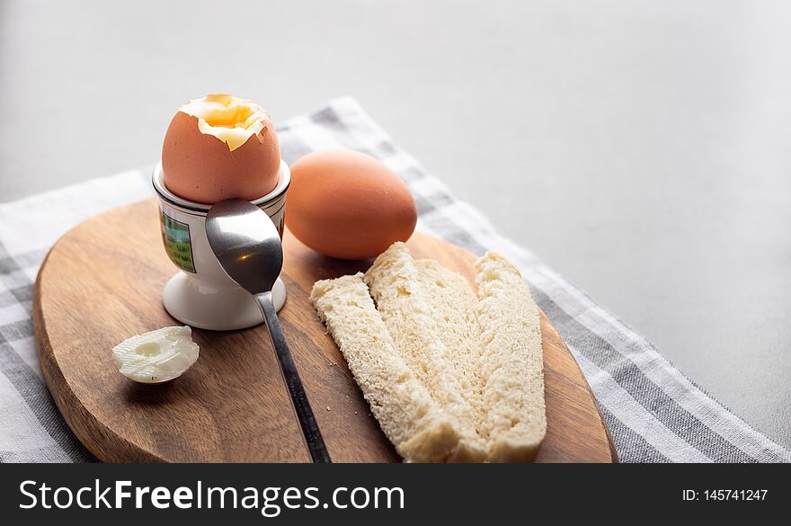 Breakfast boiled eggs with white bread on a table. Breakfast boiled eggs with white bread on a table