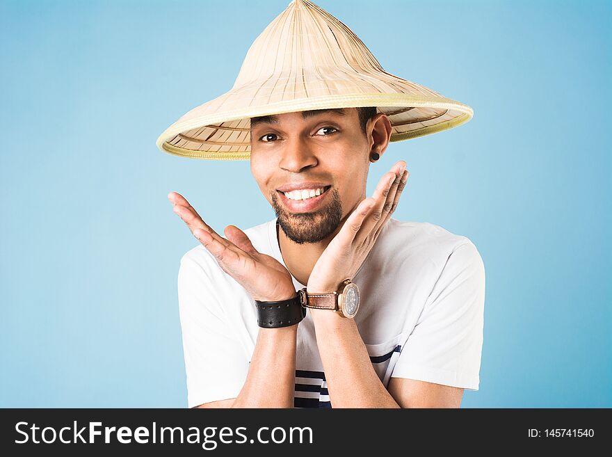 Black guy in a straw hat on a blue background