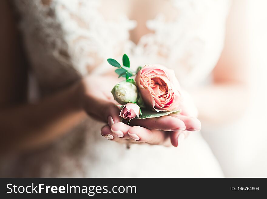 Bride holding big and beautiful wedding bouquet with flowers.