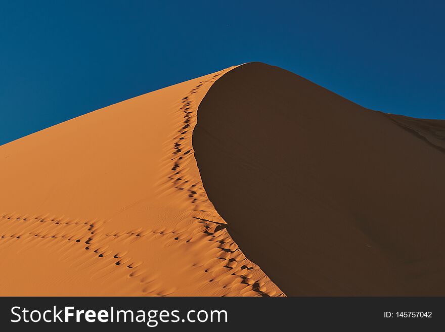 Large dune under a blue sky