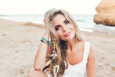 Free Closeup Portrait Of Attractive Blonde Girl With Long Hair And Blue Eyes Sitting On Beach. She Wears White Dress Royalty Free Stock Photography - 145799657