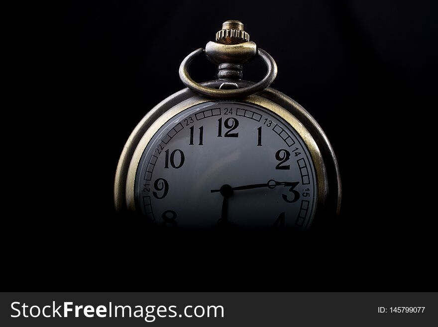 Retro style pocket watch on a dark background. Retro style pocket watch on a dark background