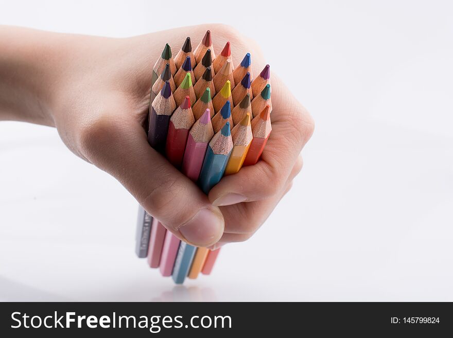 Hand holdin color pencils on a white background. Hand holdin color pencils on a white background