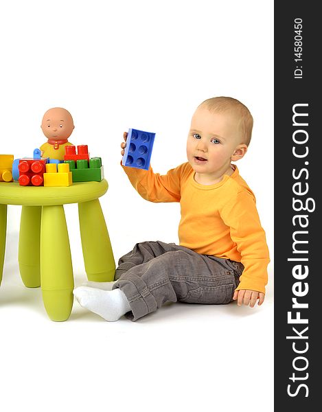 Little bayby is playing with block on the chair. Little bayby is playing with block on the chair