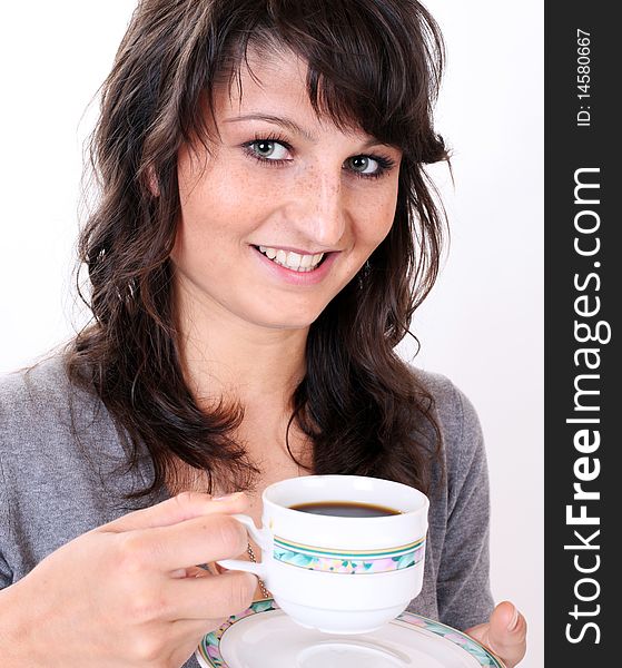 Young girl is drinking traditional pure black cup of coffee in front of a white background. Young girl is drinking traditional pure black cup of coffee in front of a white background