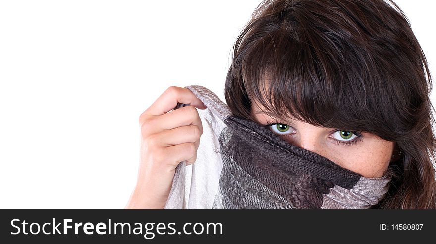 Beautiful woman is hiding her face behind a scarf. photo is isolated in front of a white background. Beautiful woman is hiding her face behind a scarf. photo is isolated in front of a white background