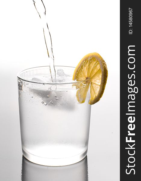 Glass of ice water with a lemon slice. Glass of ice water with a lemon slice